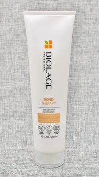 Biolage Bond Therapy Conditioner for overprocessed, damaged hair smooths, nourishes and builds bonds from the inside out. Ideal for medium to coarse overprocessed, damaged hair.

Conditioner for overprocessed, damaged hair that smooths, nourishes and builds bonds from the inside out.