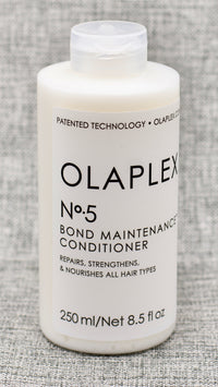 Olaplex Nº.5 Bond Maintenance Conditioner. A highly-moisturizing, reparative conditioner for all hair types. Leaves hair easier to manage, shinier, and healthier with each use. Protects and repairs damaged hair, split ends, and frizz by re-linking broken bonds. It is color-safe and will strengthen and leave your hair stronger than ever